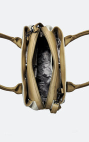 An overhead view of a beige leather handbag with its main compartment open, showing a black and white patterned lining, on a light gray background.