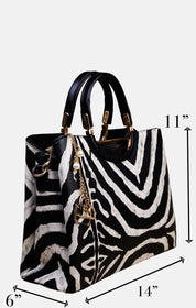 A zebra-print handbag with black leather handles and gold-tone hardware, shown with dimension arrows and labels indicating 11 inches tall, 14 inches wide, and 6 inches deep on a light gray background.