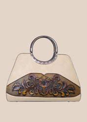 Light moca brown handbag with a floral tooled design front view