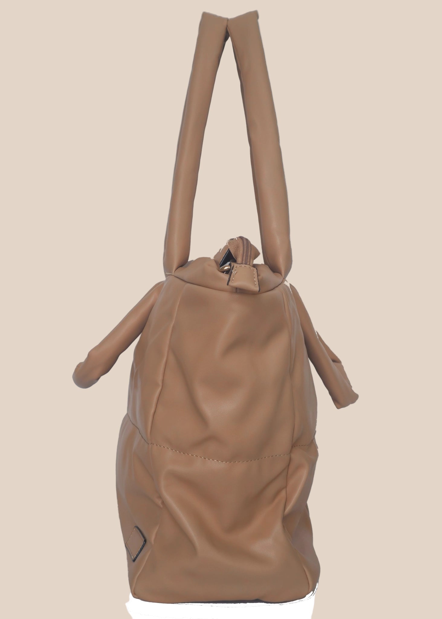 Brown smooth form handbag with a strap and handles side view