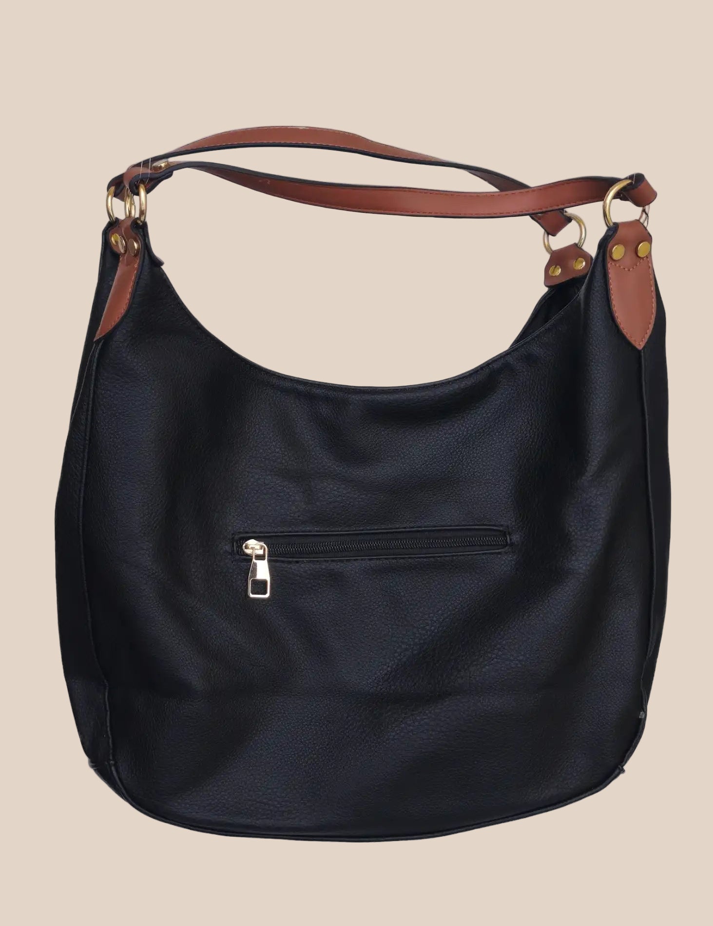 Black leather handbag with brown accents on a beige background back