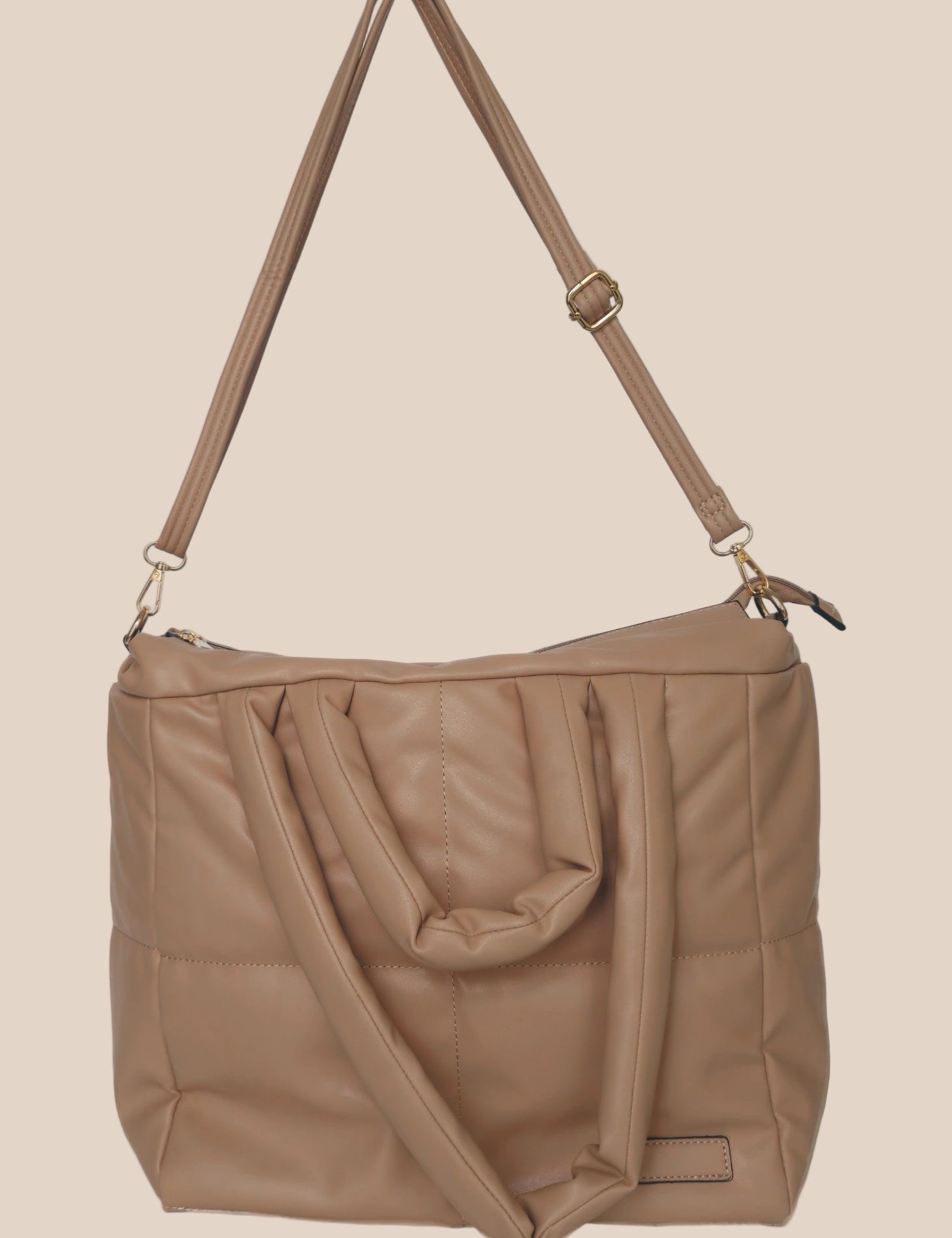 Brown smooth form handbag with a strap and handles front view