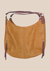 Brown leather handbag with purple accents on a beige background front