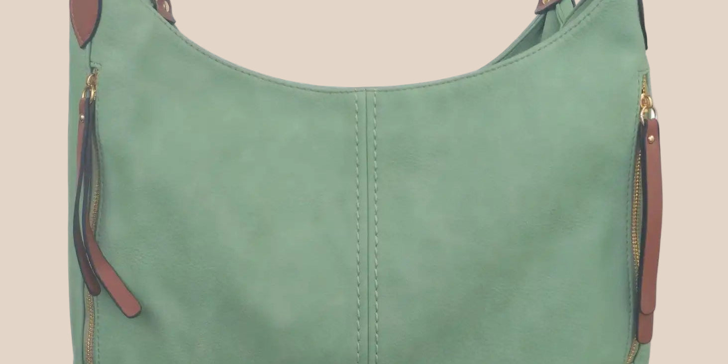 Green handbag with brown accents on a beige background front