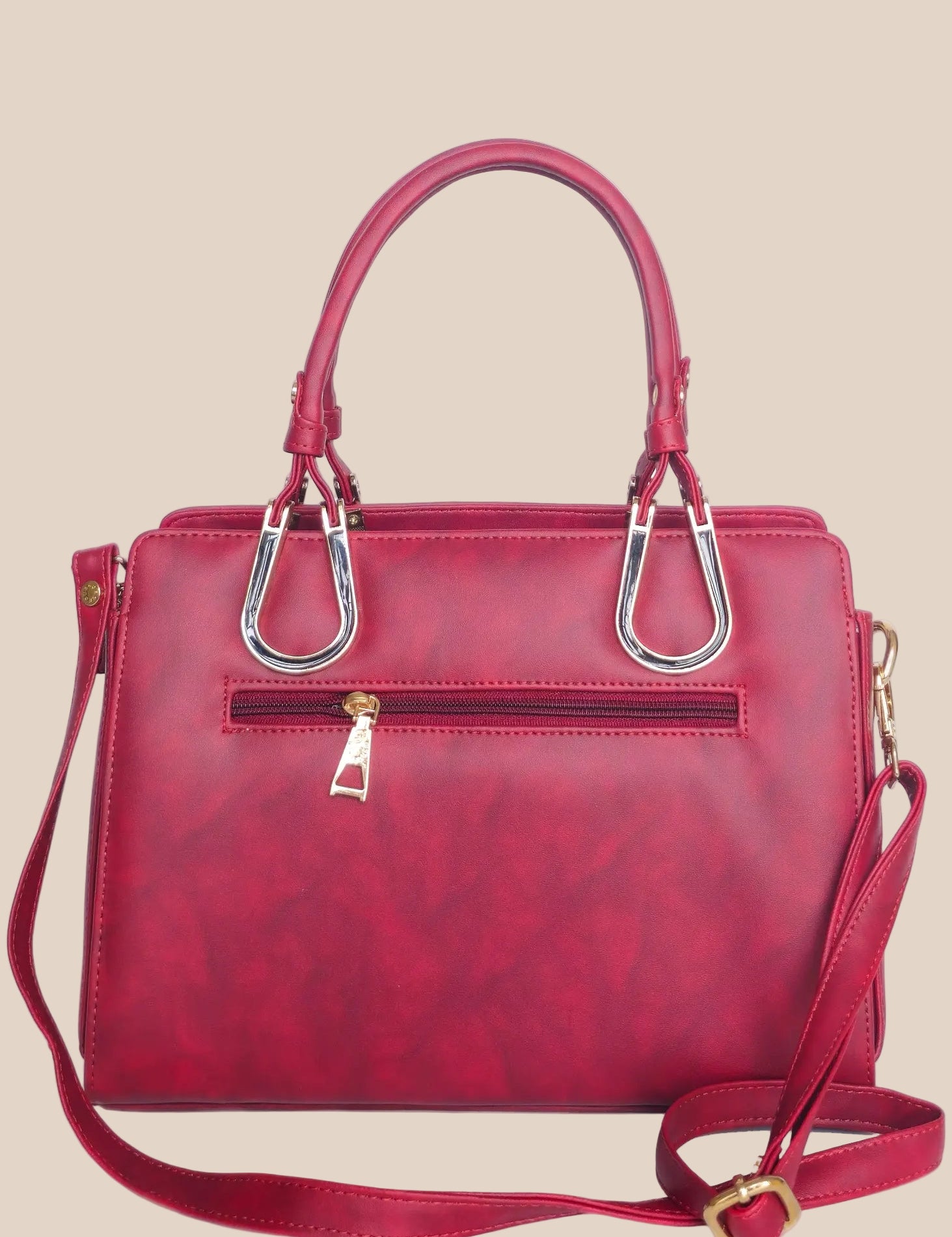 Dusty pink handbag with gold accents back view