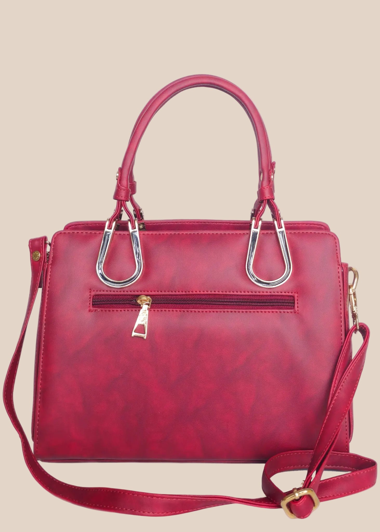 Dusty pink handbag with gold accents back view