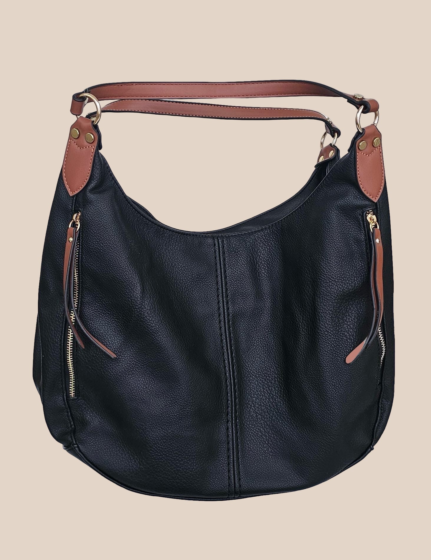 Black leather handbag with brown accents on a beige background front