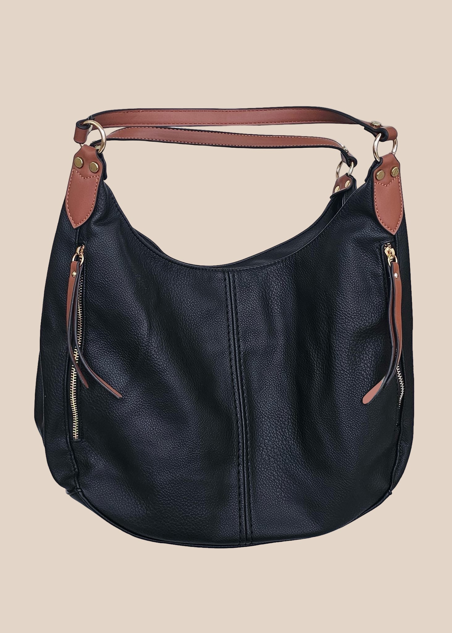 Black leather handbag with brown accents on a beige background front