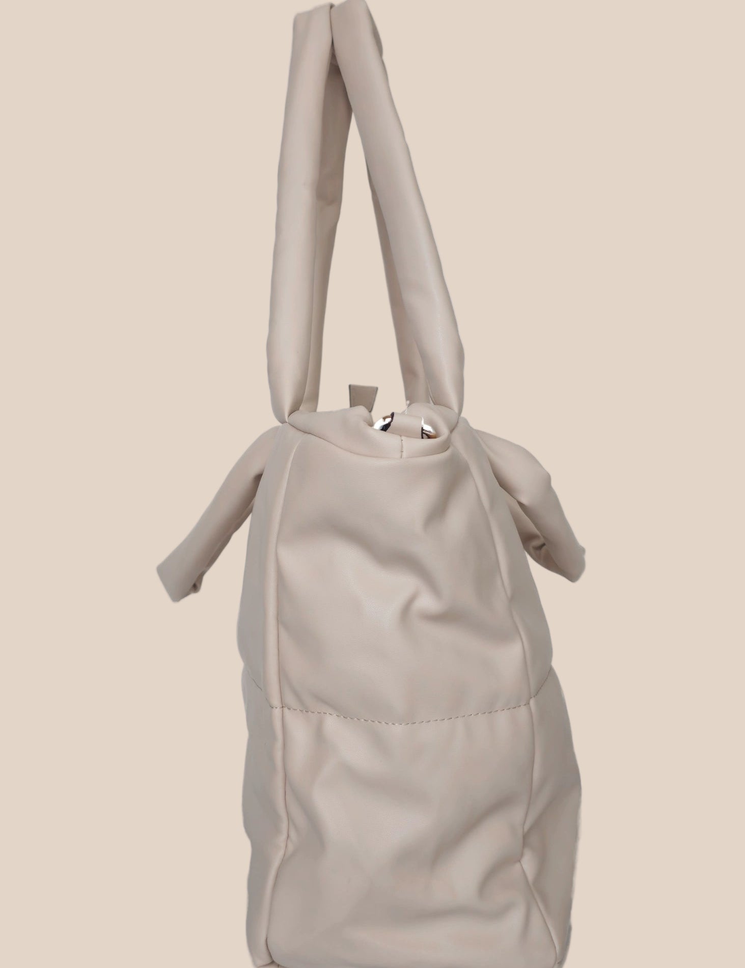 Light Gray smooth form handbag with a strap and handles side view