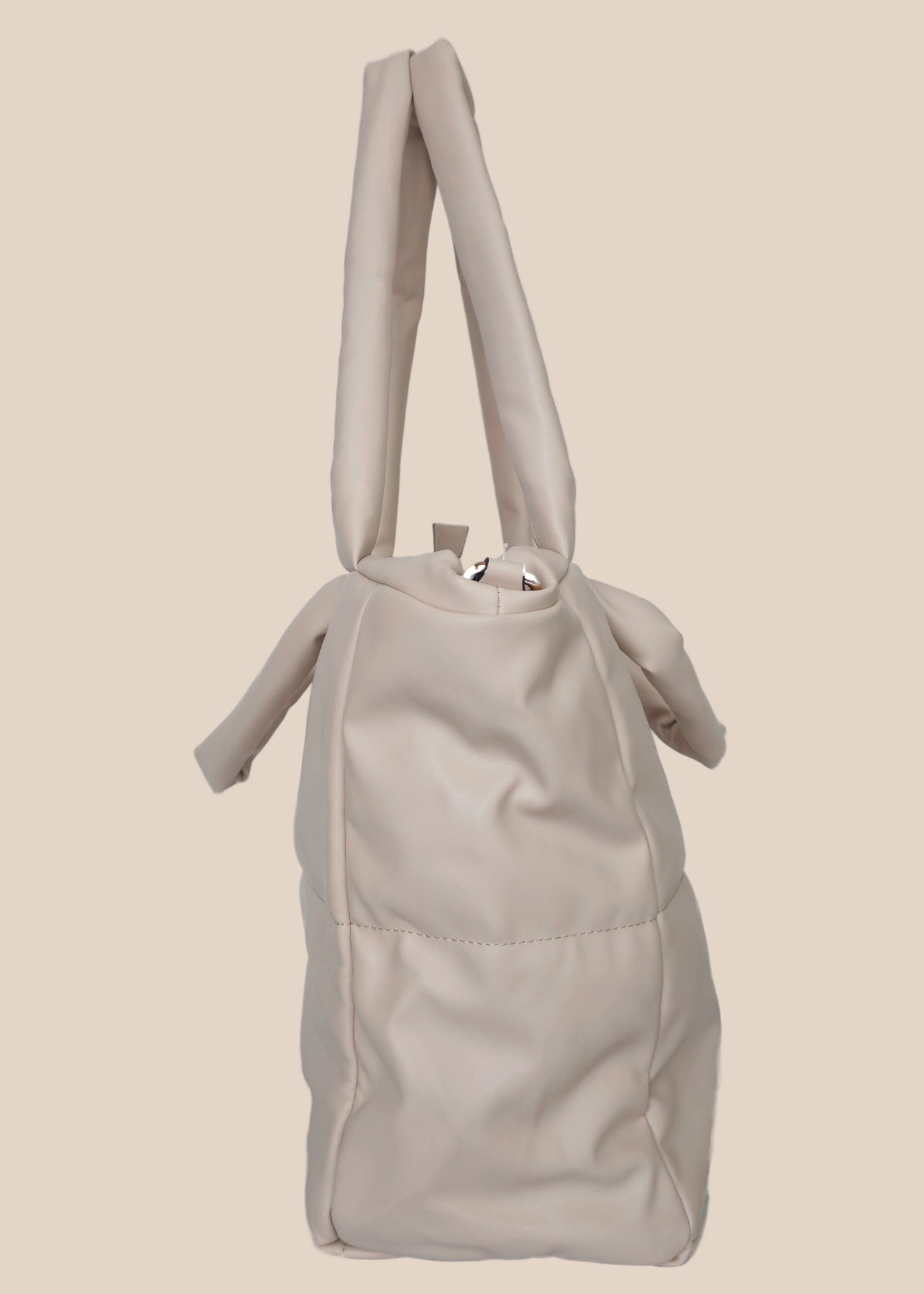 Light Gray smooth form handbag with a strap and handles side view