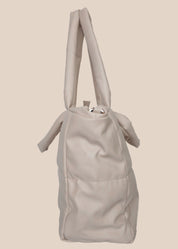 Light Gray smooth form handbag with a strap and handles side view