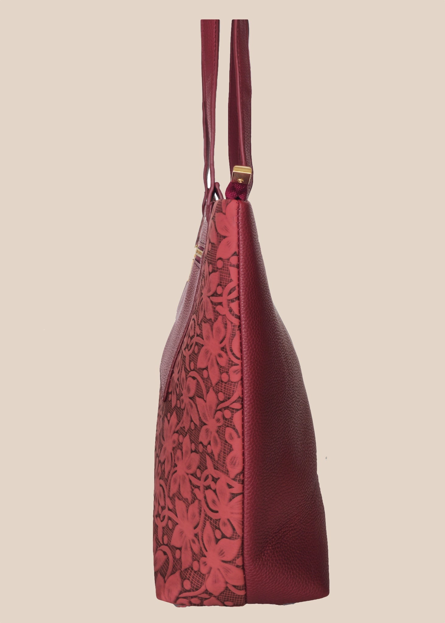 Burugundy floral-patterned handbag with a gold zipper side view