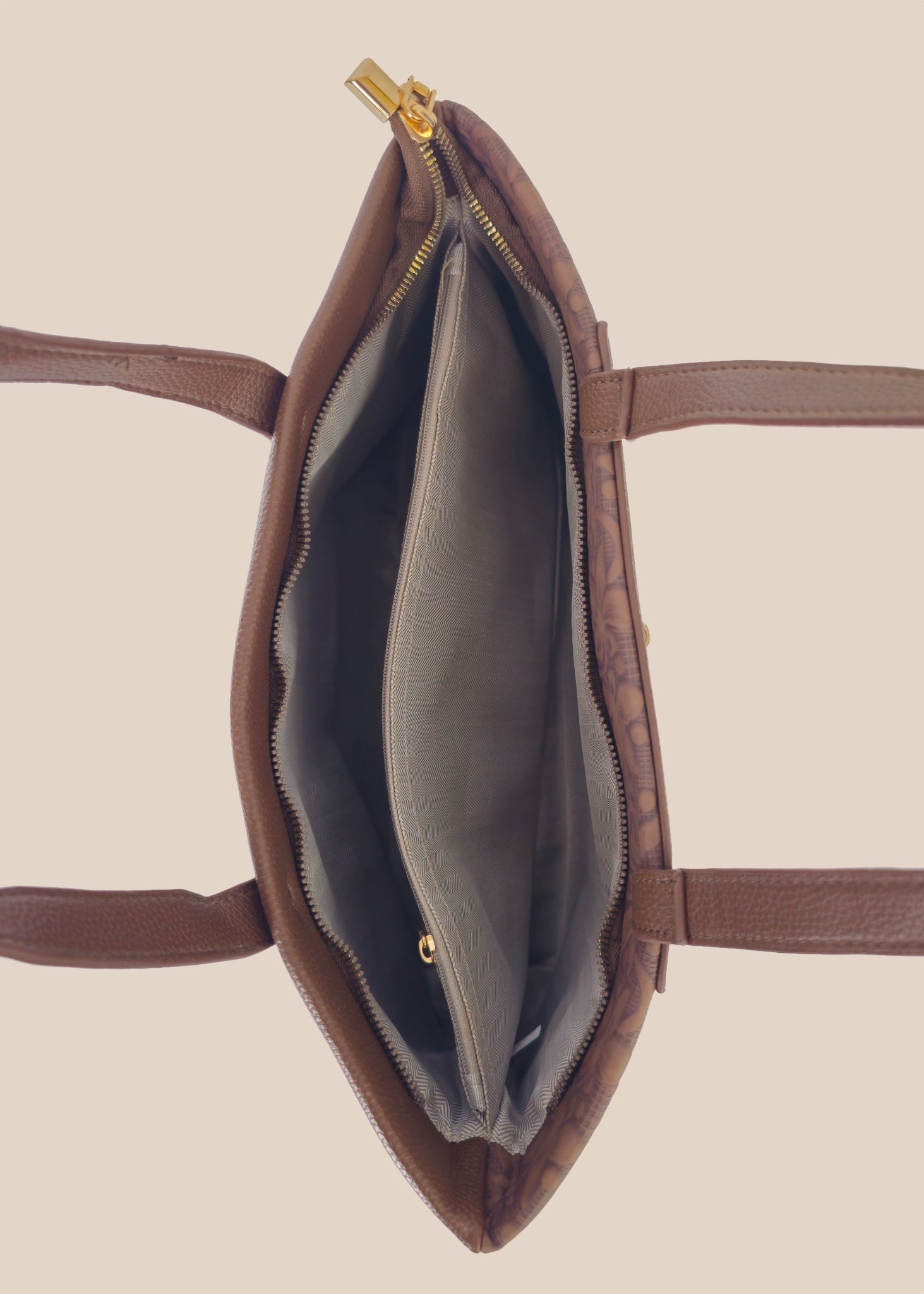 Tan floral-patterned handbag with a gold zipper interior view