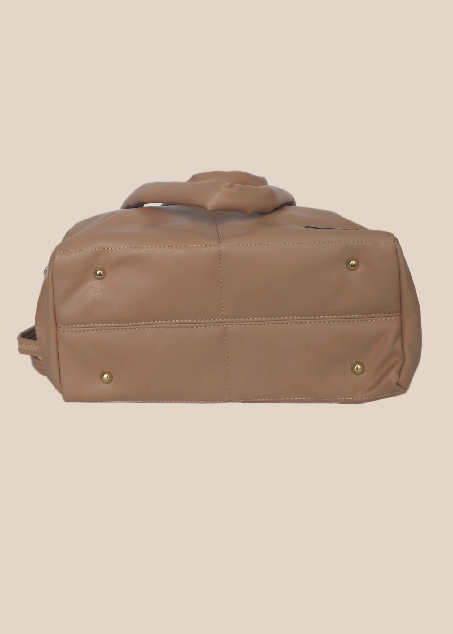 Brown smooth form handbag with a strap and handles bottom view