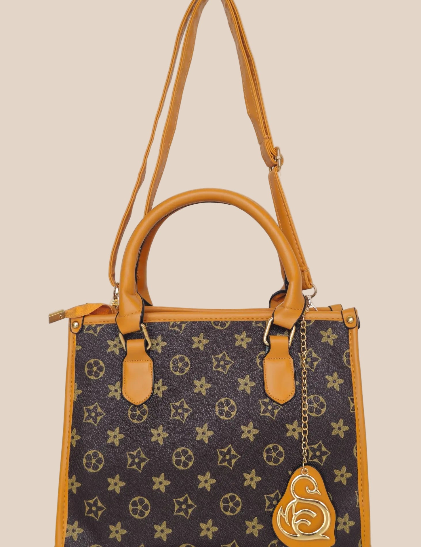 Handbag with a star pattern and a brown handle front view