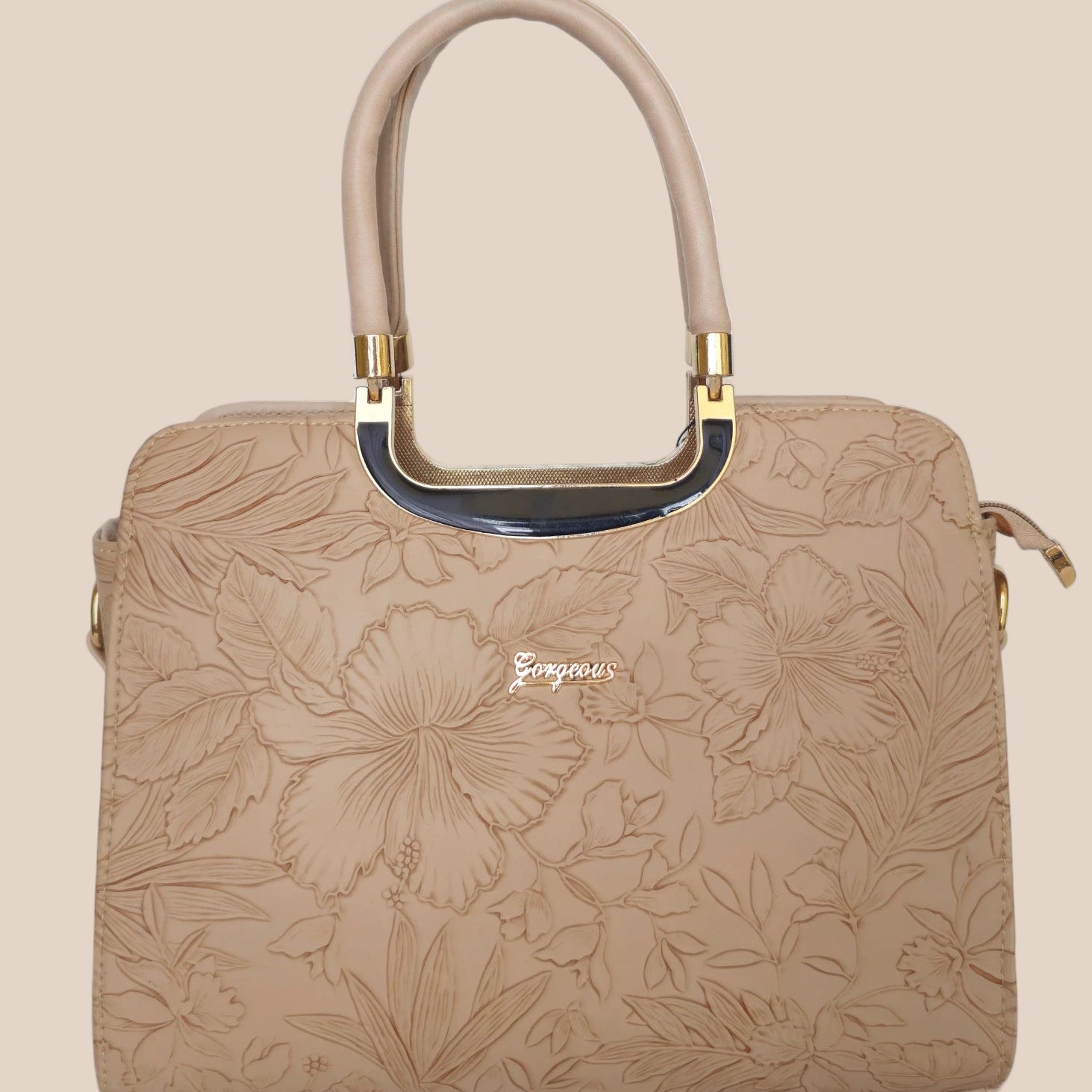 Beige handbag with a floral pattern and a gold handle front view