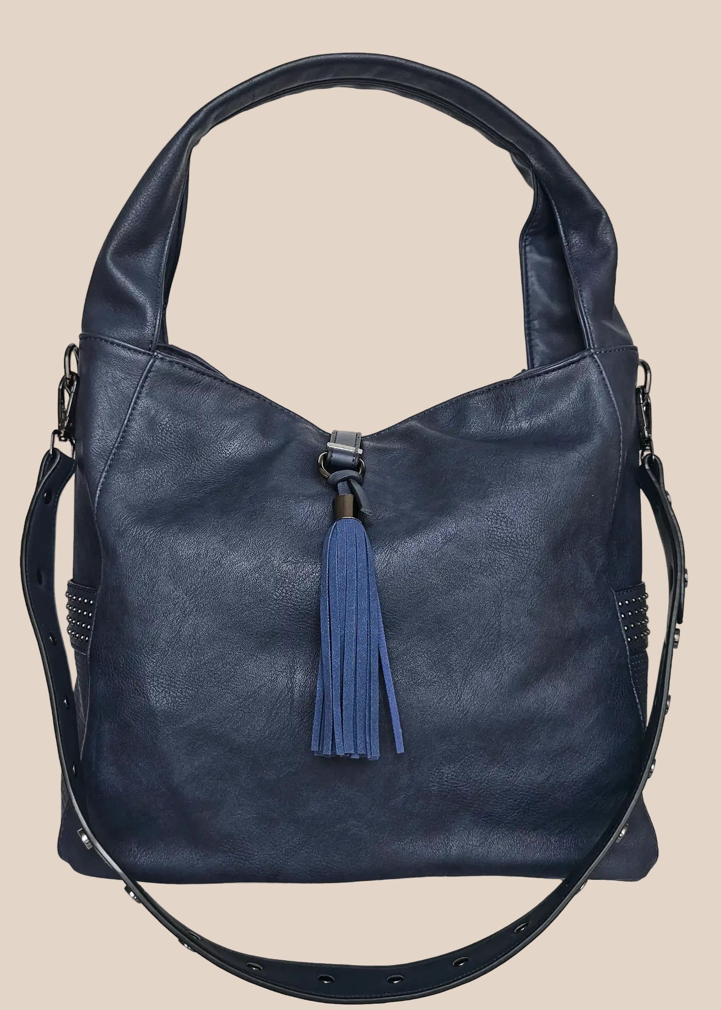 Blue handbag with a tassel on a beige background front view