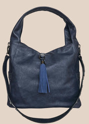 Blue handbag with a tassel on a beige background front view