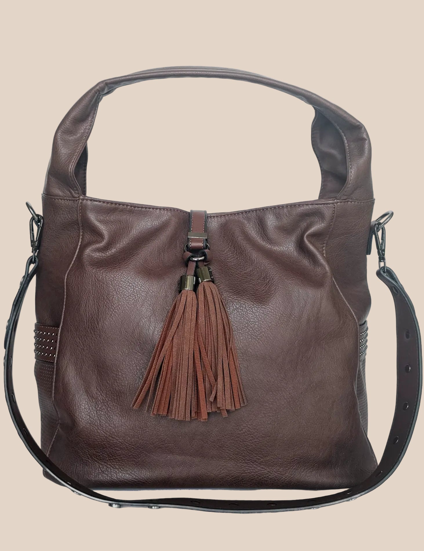 Brown leather handbag with a tassel on a beige background front view
