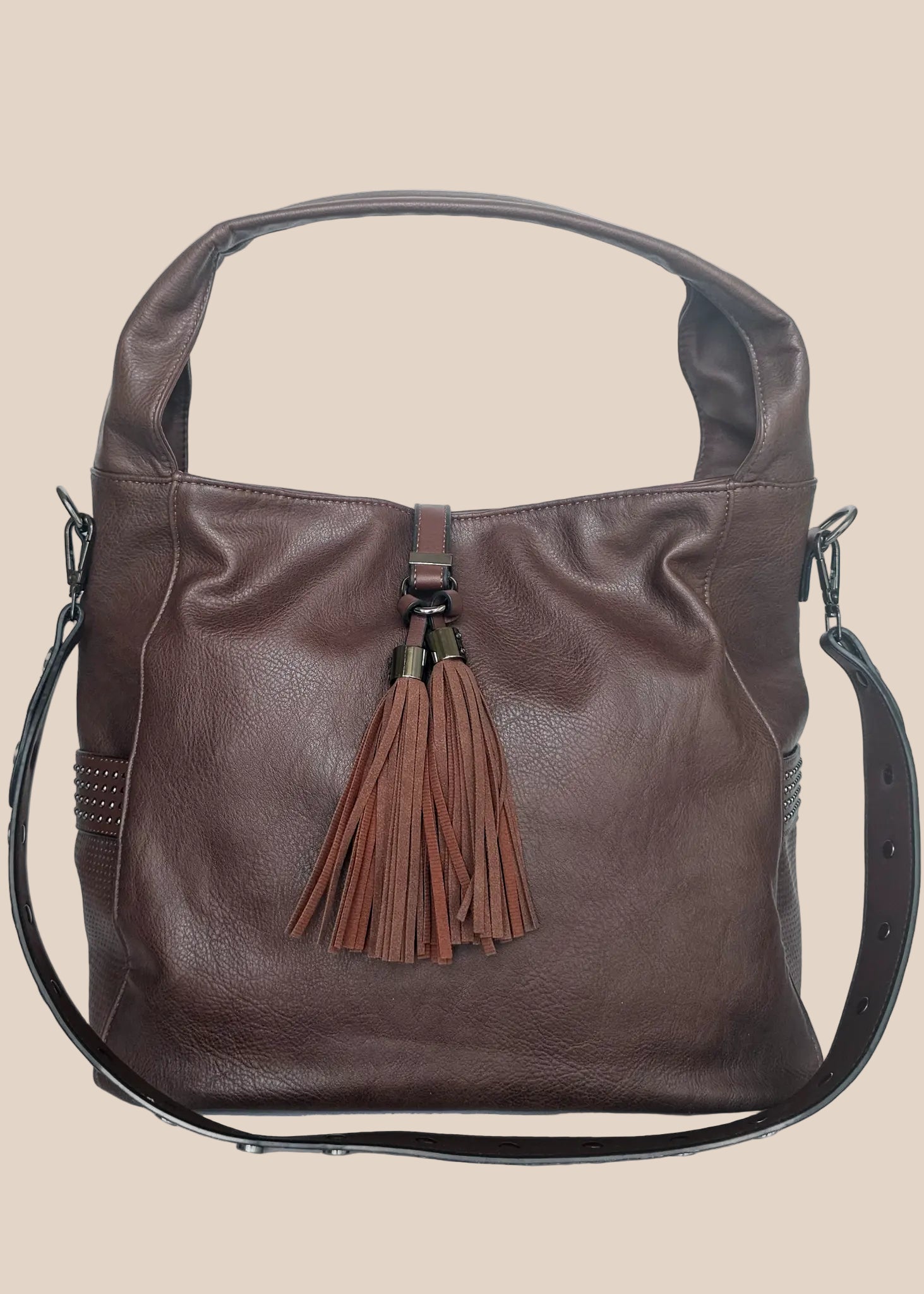 Brown leather handbag with a tassel on a beige background front view