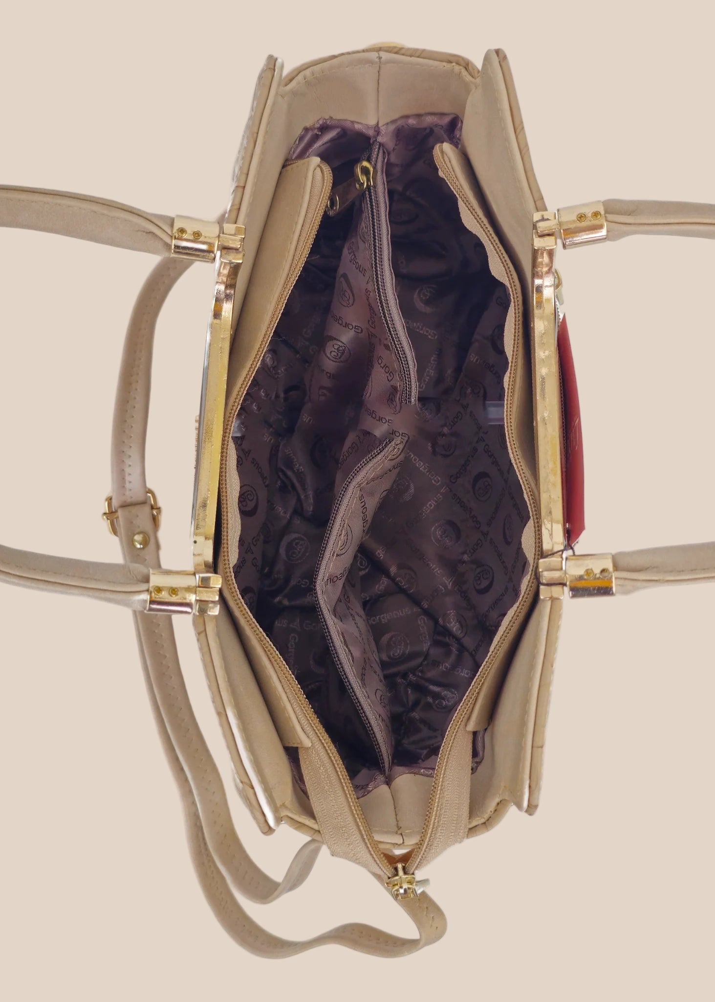 Beige handbag with a floral pattern and a gold handle inside view