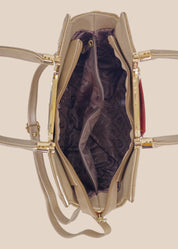 Beige handbag with a floral pattern and a gold handle inside view