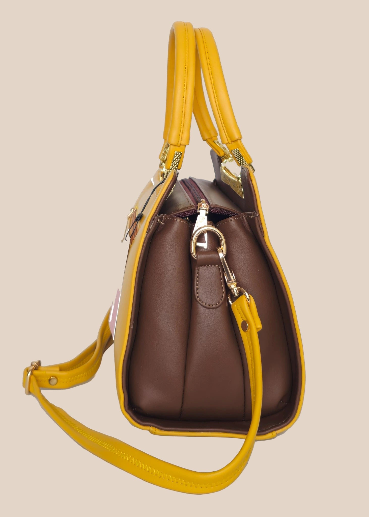 Brown handbag with yellow handles and a strap side view