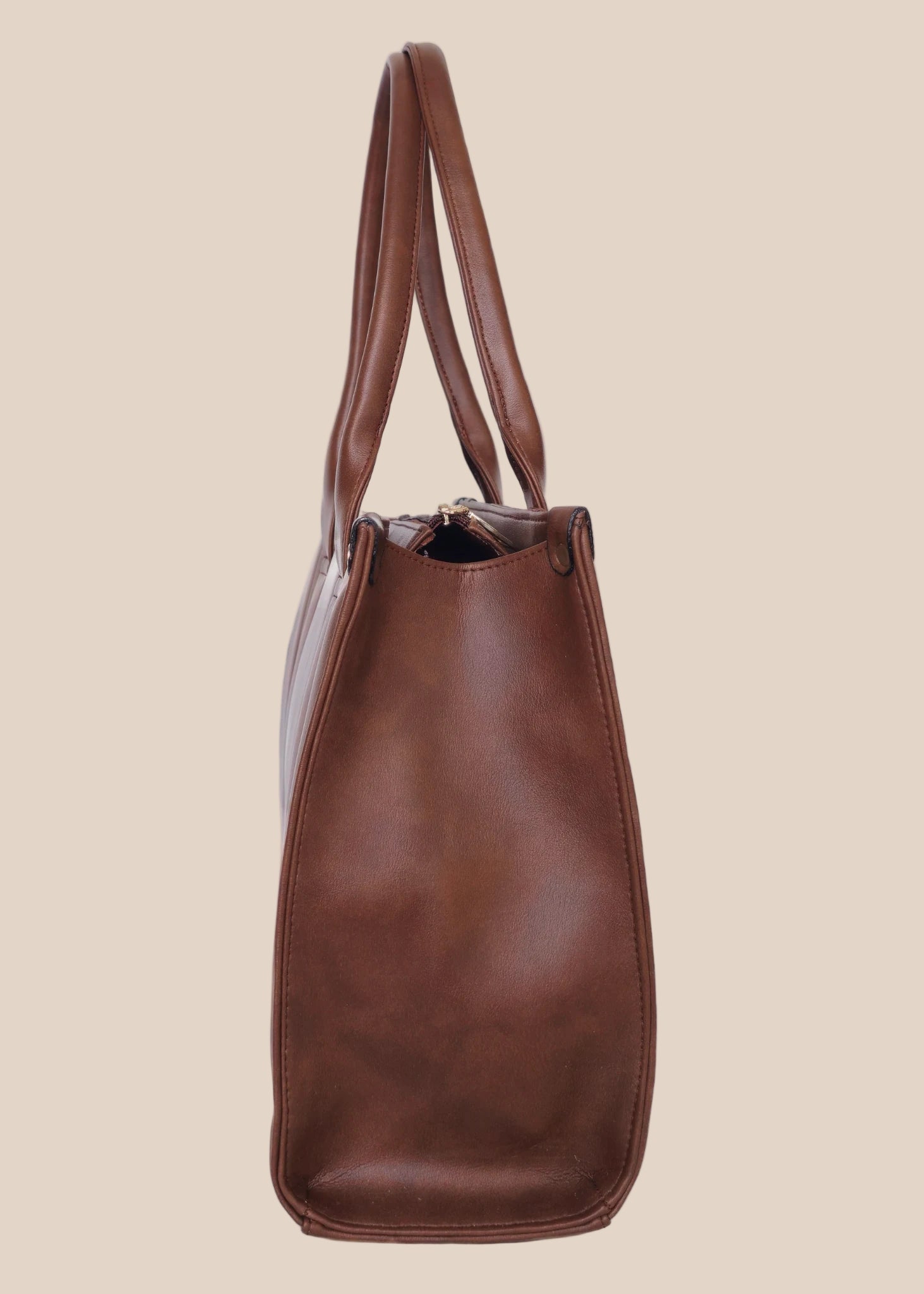 Brown leather tote bag with 'GORGEOUS' branding from doodluxe side view