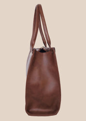 Brown leather tote bag with 'GORGEOUS' branding from doodluxe side view