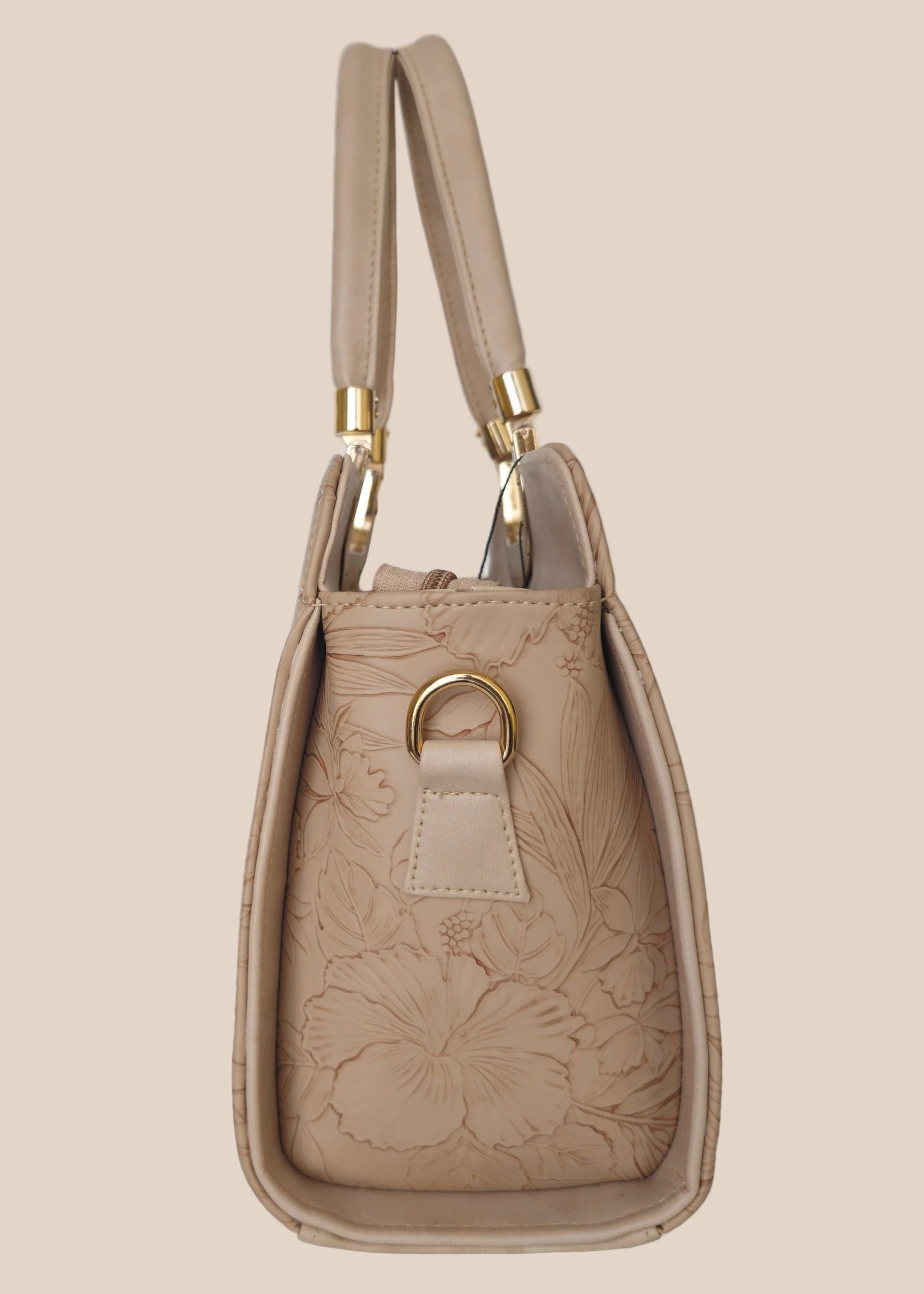 Beige handbag with a floral pattern and a gold handle side view