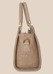 Beige handbag with a floral pattern and a gold handle side view