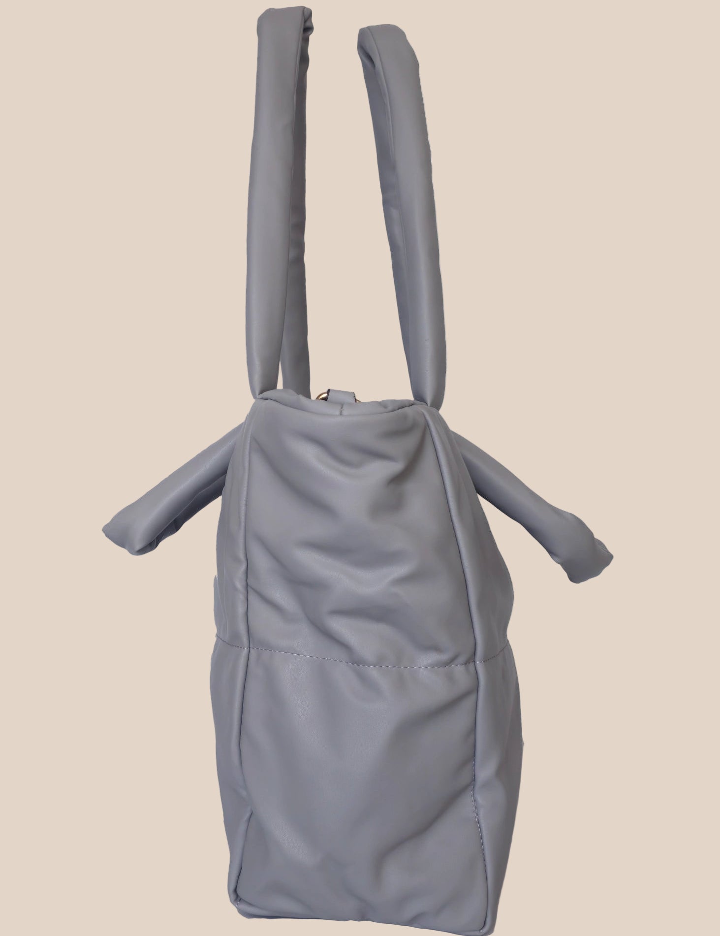 Gray smooth form handbag with a strap and handles side view