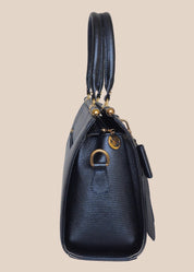 Blue handbag with gold accents, side view2