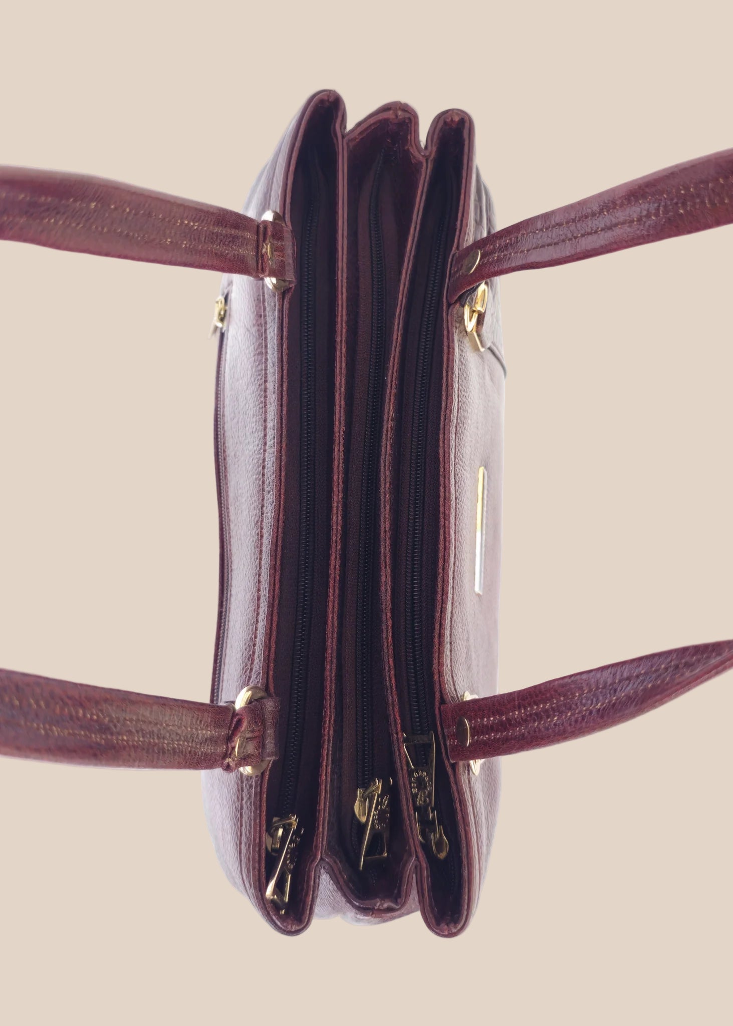 Burugundy leather handbag with gold accents top view