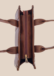 Brown leather tote bag with 'GORGEOUS' branding from doodluxe top view